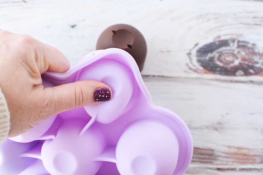 Popping hot chocolate bombs out of candy mold.