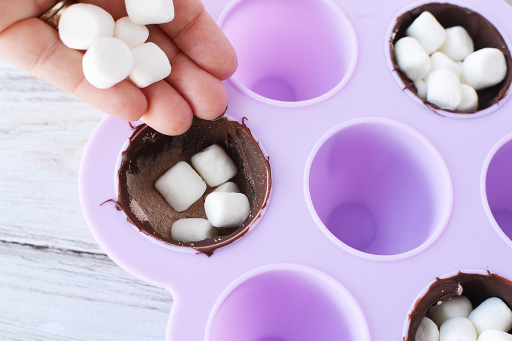 Adding marshmallows to a candy mold.