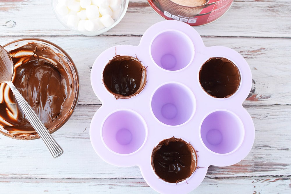 Candy mold lined with melted chocolate.