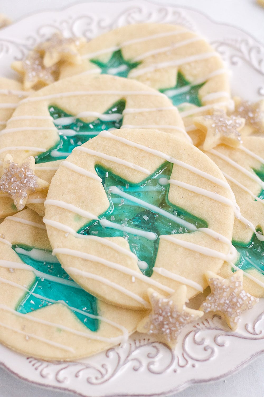 Stained-Glass blue star cookies on a white plate. 