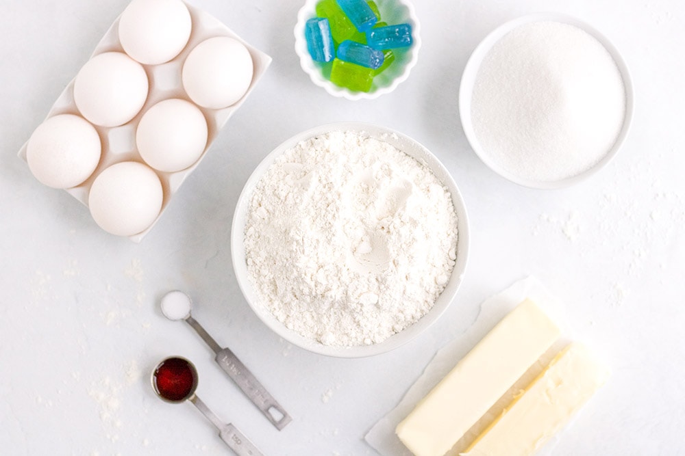 Eggs, flour, butter, vanilla, and candies for stained-glass cookies on a table. 
