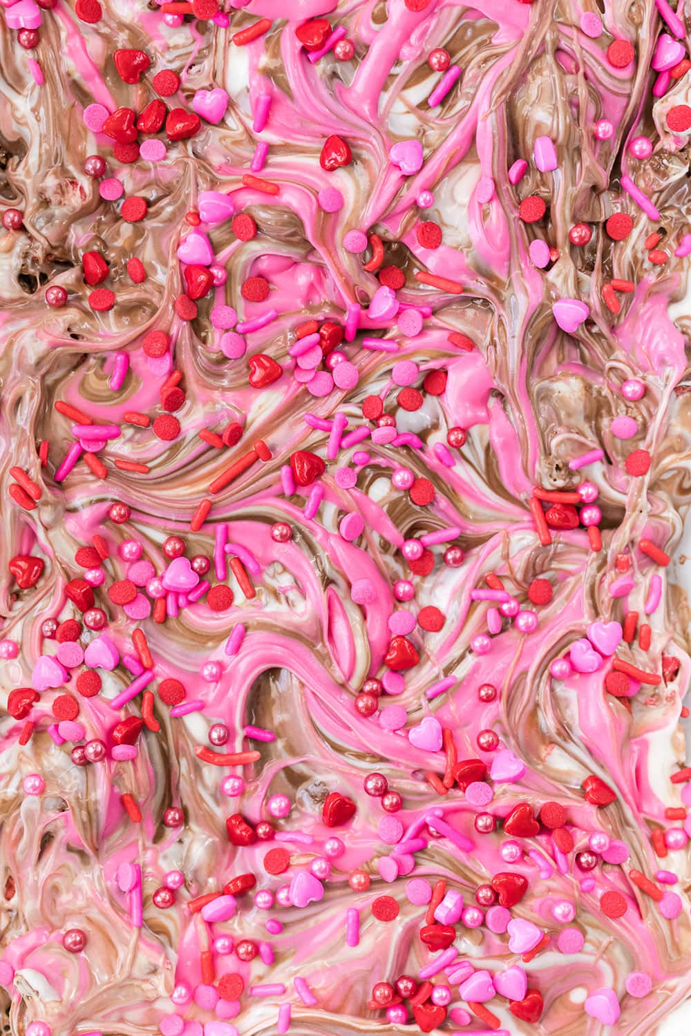 Closeup of chocolate bark candy sprinkled with Valentine's day sprinkles.