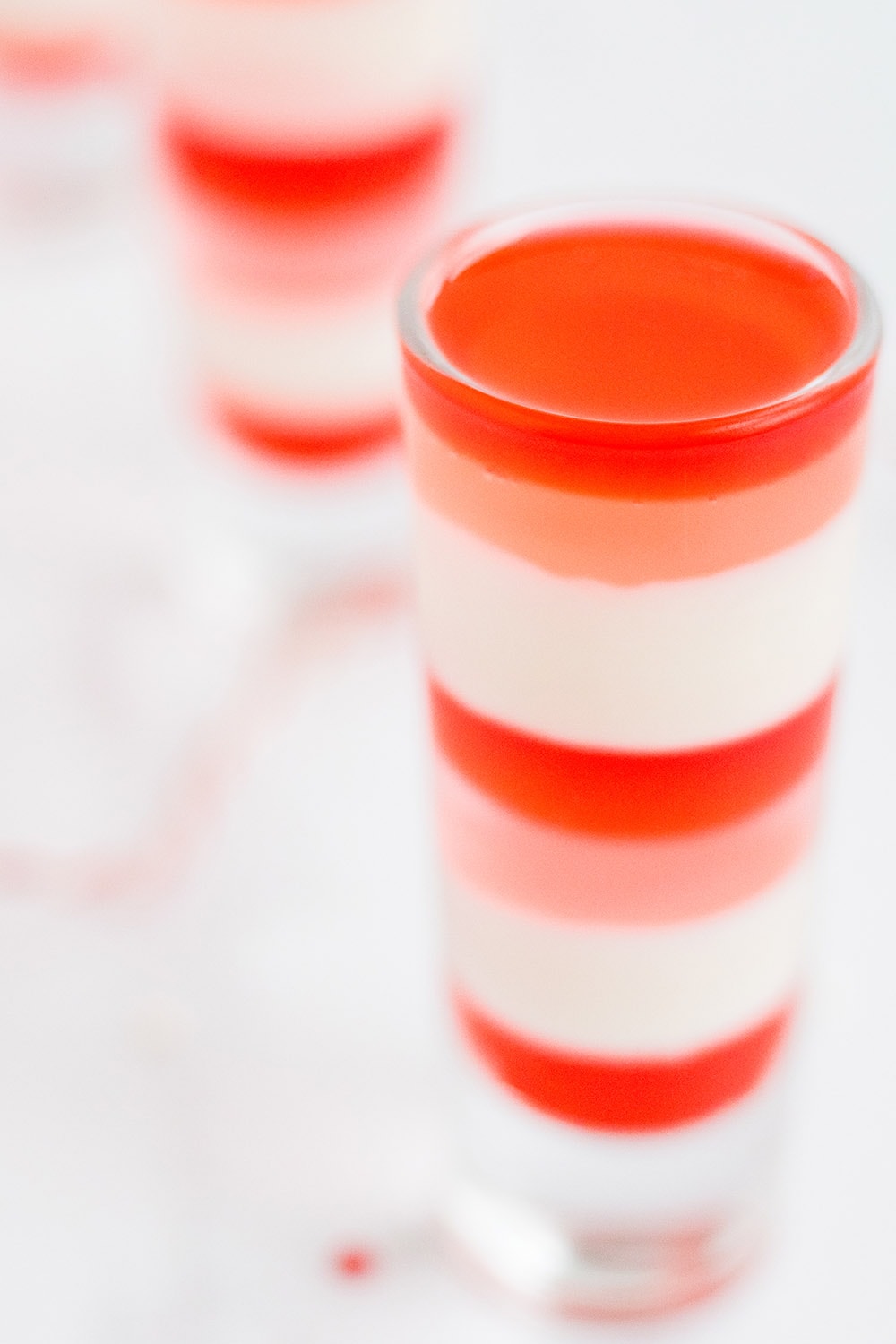 Dessert shooters with Valentine's Day layered gelatin in them.