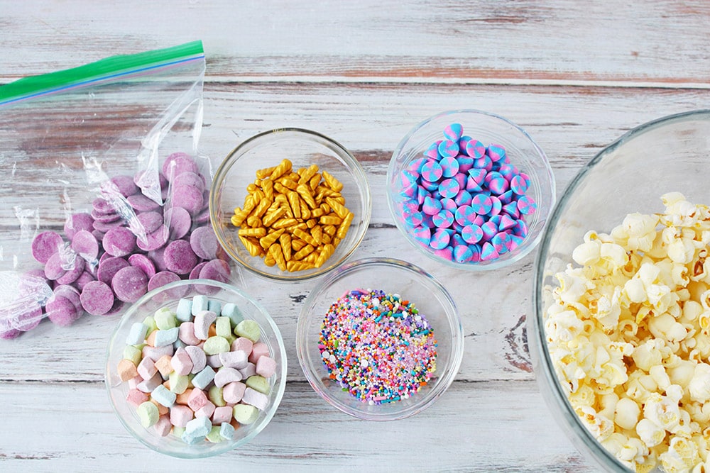 Bowls of ingredients to make unicorn popcorn. 