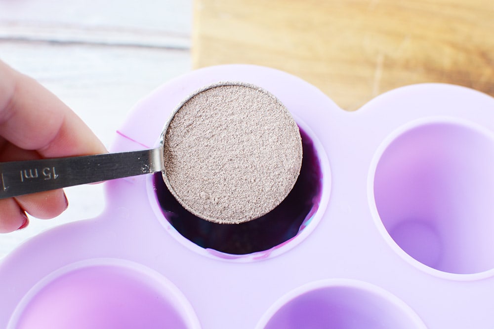 Pouring hot cocoa into a candy mold.