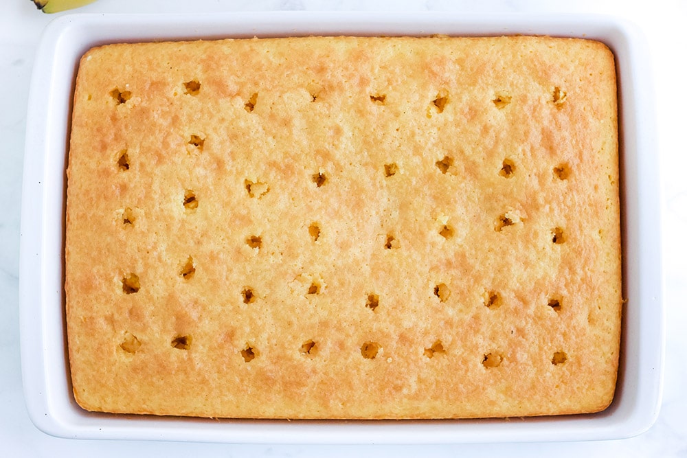 Yellow cake with holes poked in it.