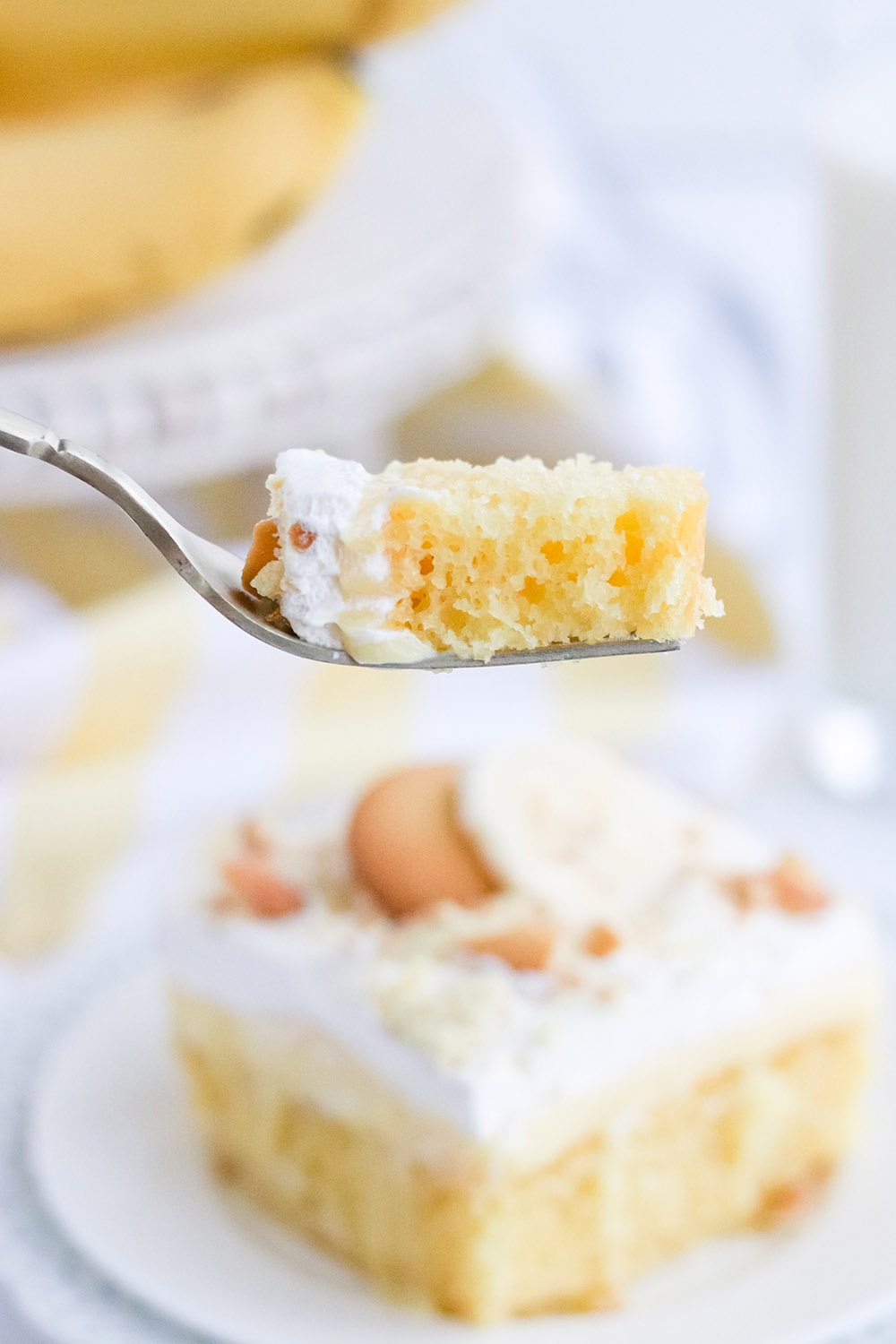 Forkful of banana poke cake.
