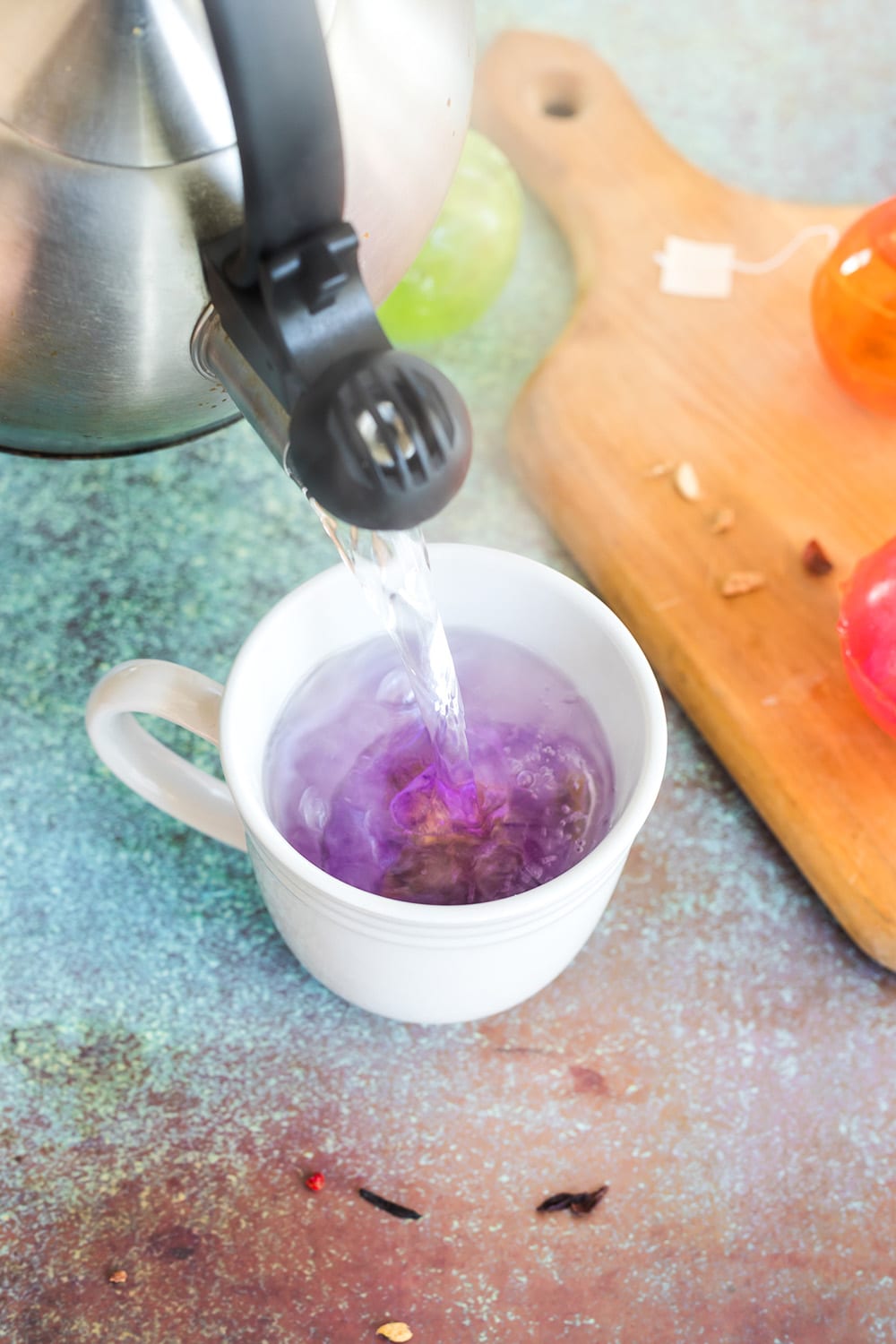 Pouring water into a mug with a bag of tea. 