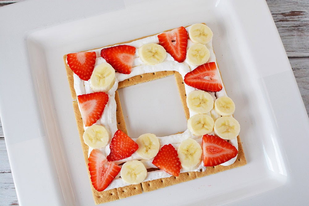 Strawberries, bananas, and whipped cream on graham crackers.