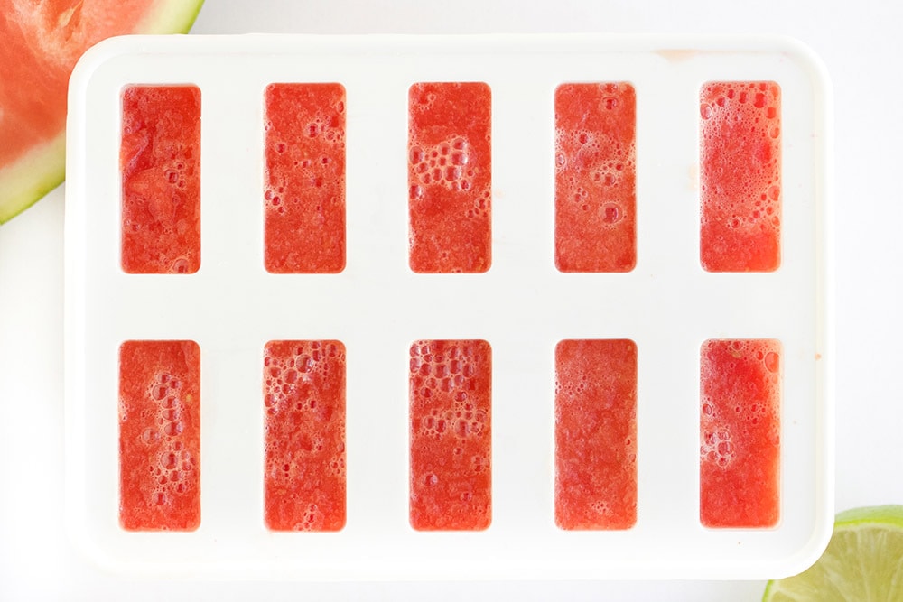 Red popsicles poured into a mold.