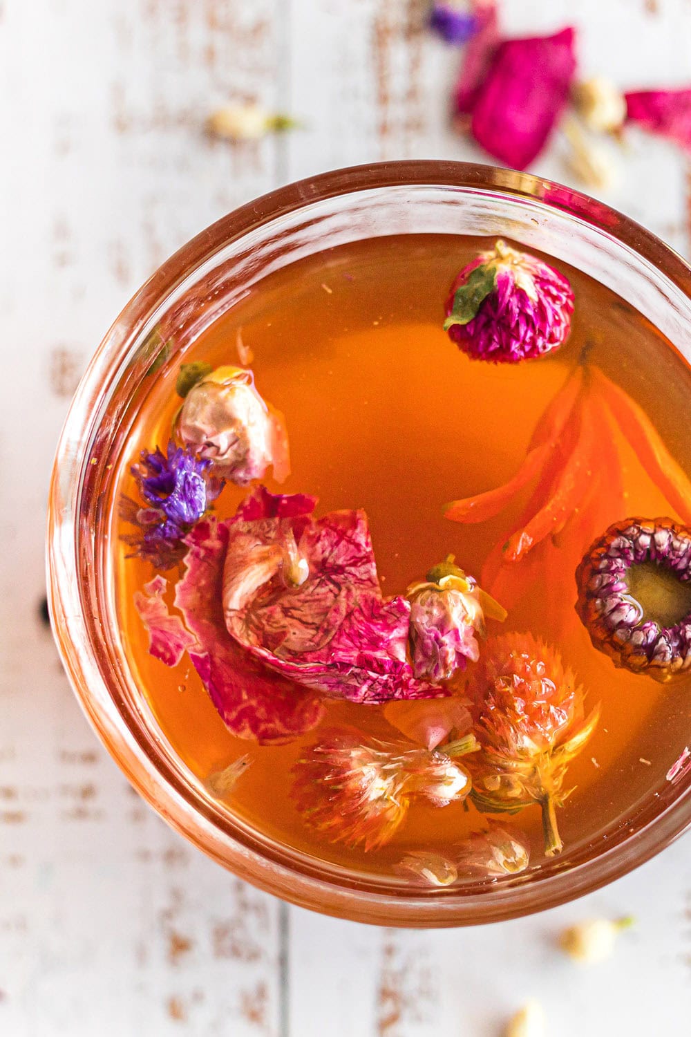 Mug full of tea and flowers.
