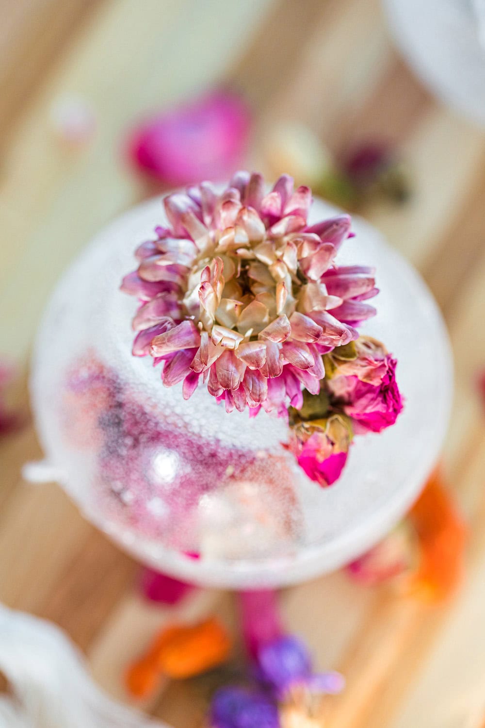 Tea drop with a flower on it on a board.