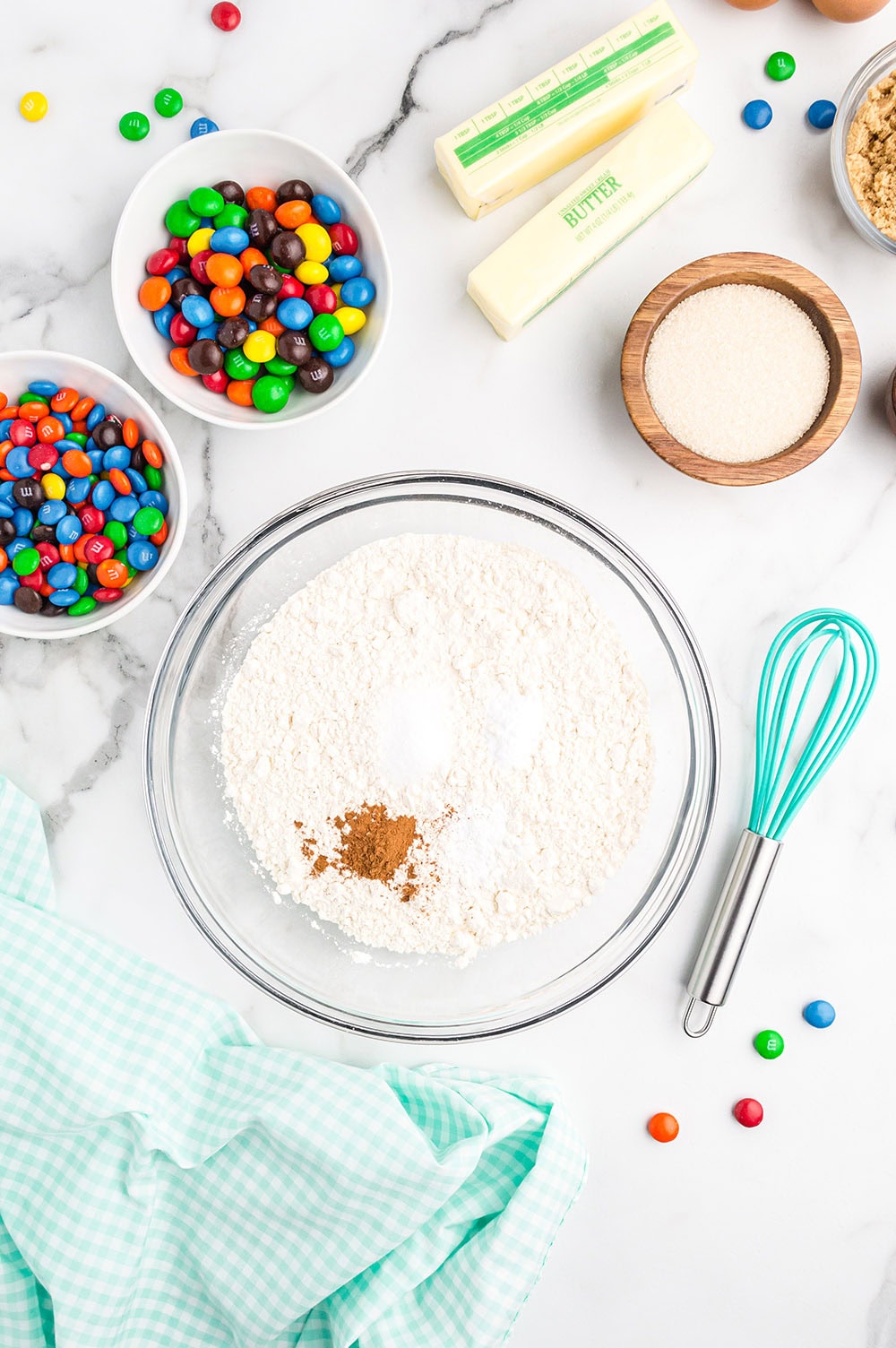 Bowls of ingredients to make M&M cookies.