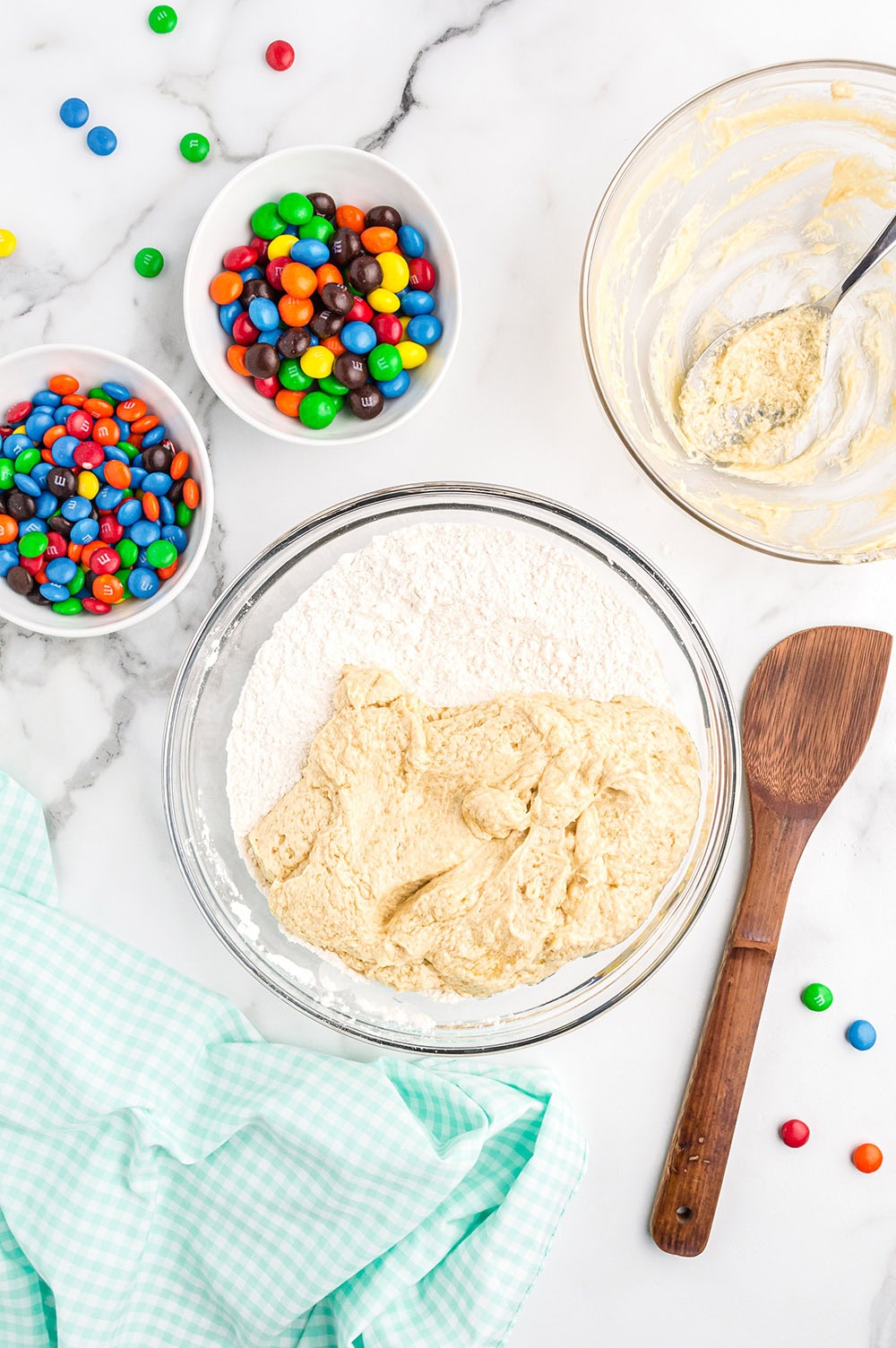 Mixing ingredients together for M&M cookies.