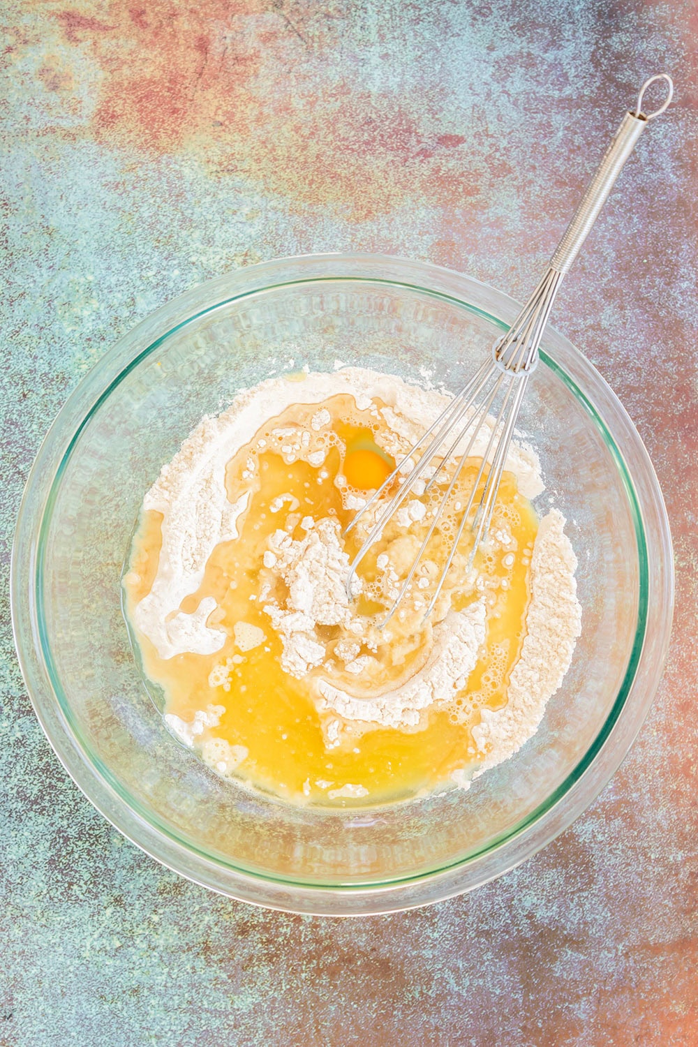 Four and egg in a mixing bowl.