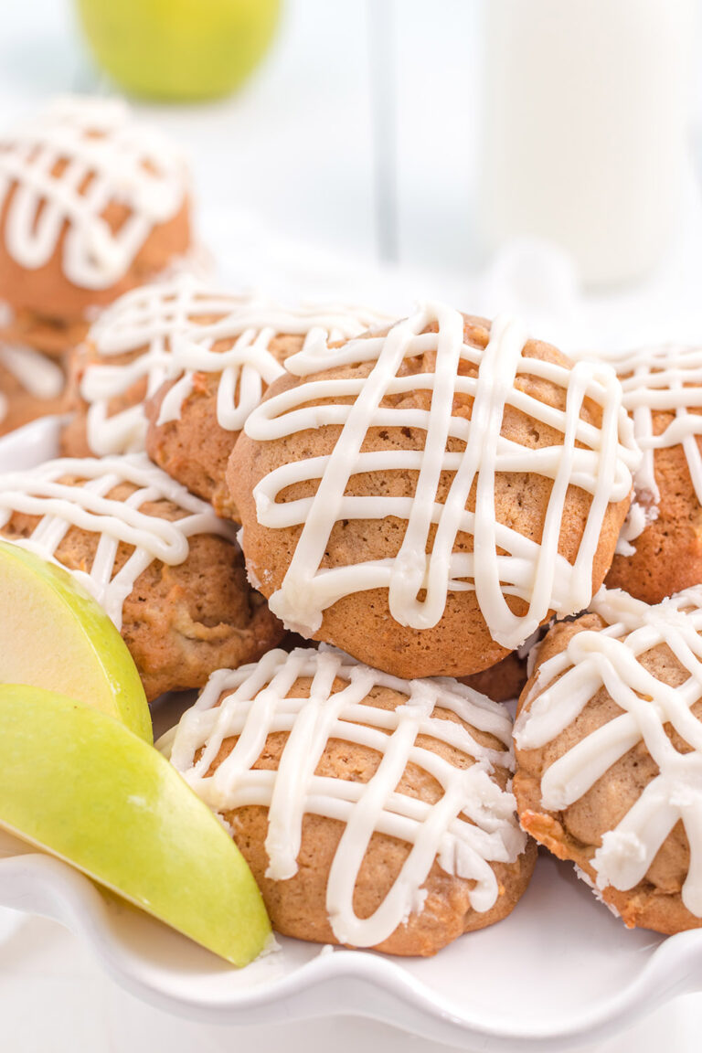 Plate of apple cookies topped with glaze.