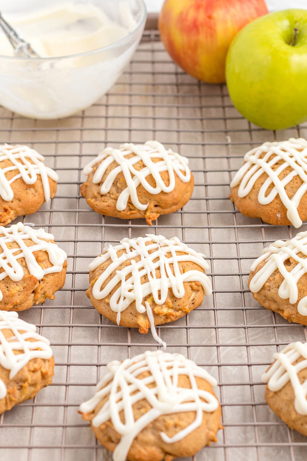 Glazed apple cookies on a rack.