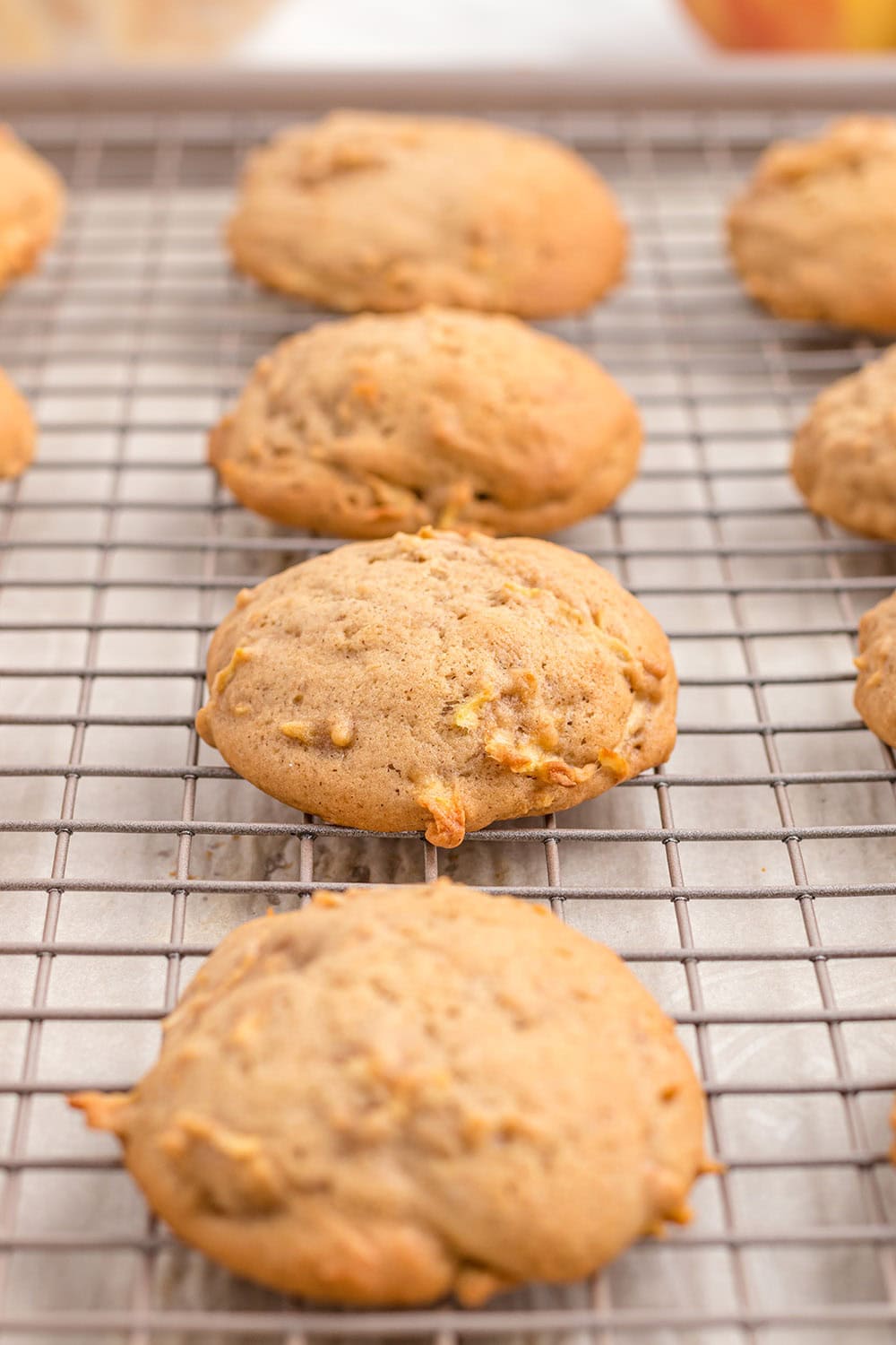 Apple cookies on a cooling rack.