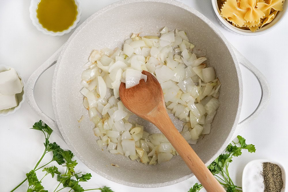 Sautéing onions in a pan.
