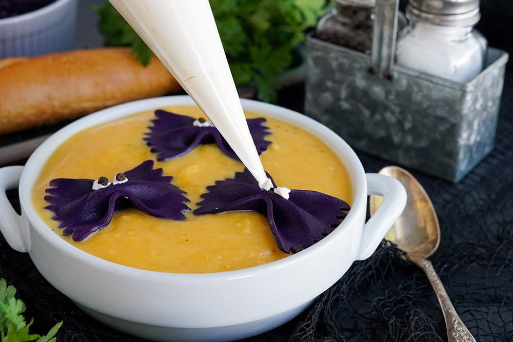 Piping eyes onto pasta bats in soup.