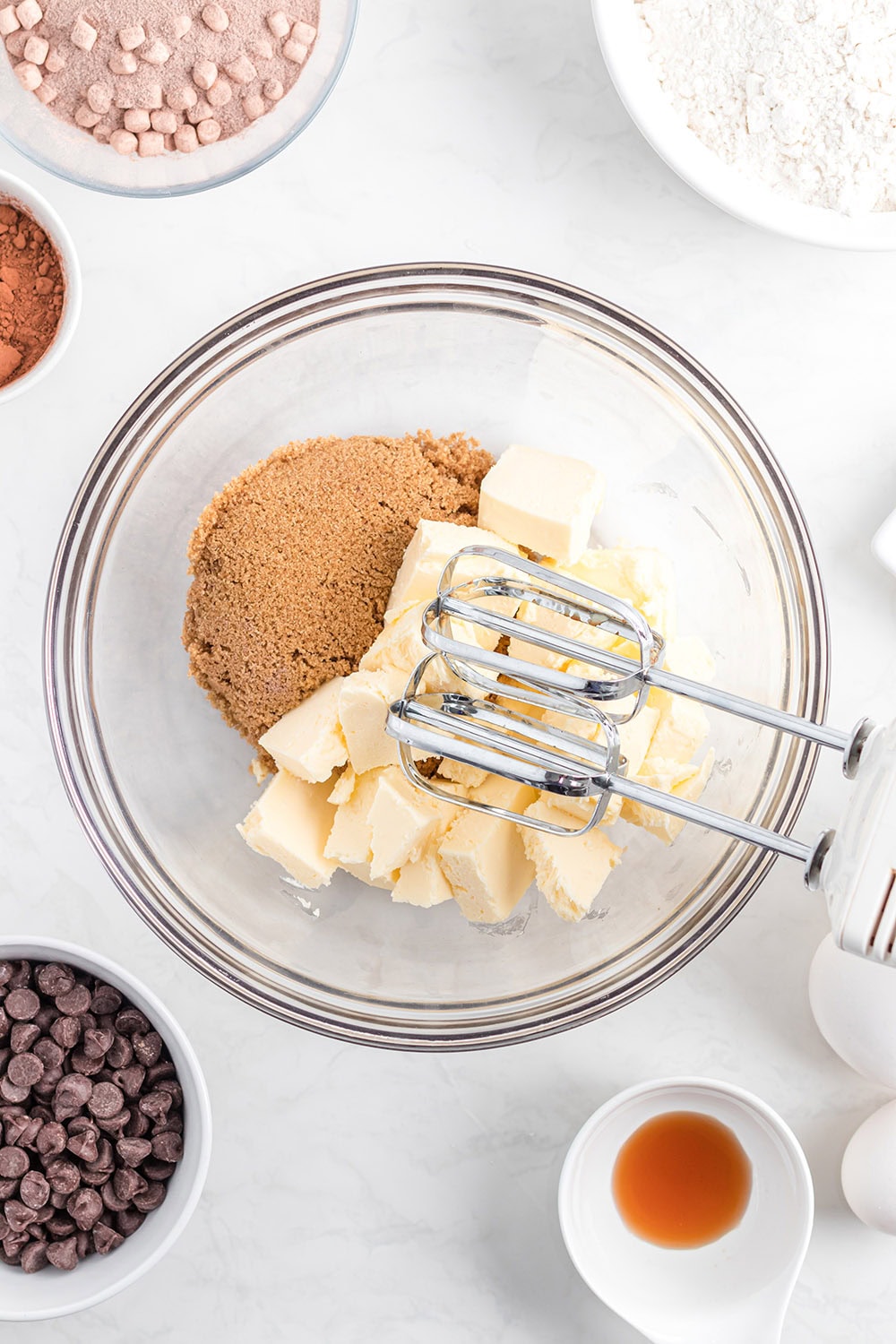 Butter and brown sugar in a bowl with a mixer.