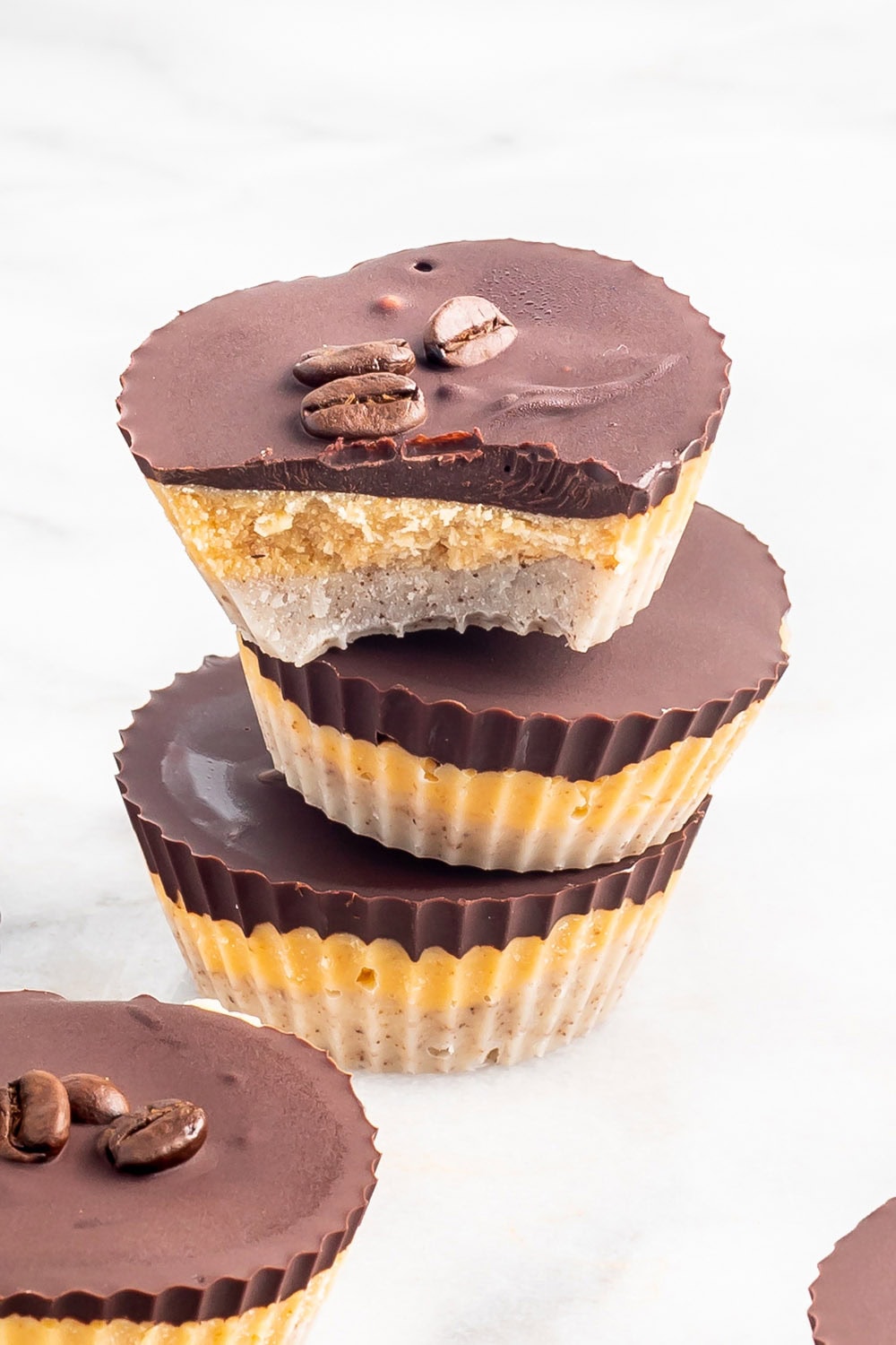 Chocolate pumpkin layered candy cups stacked.