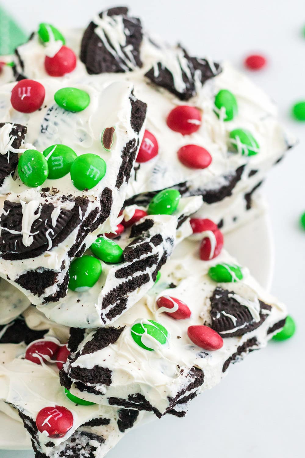 Plate full of holiday oreo bark candy with m&ms.