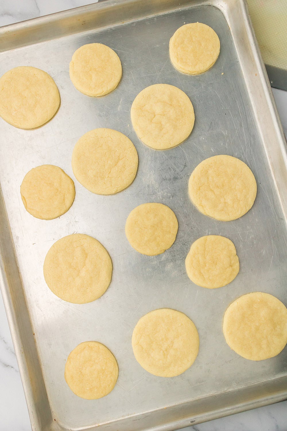Circles of cookie dough on a baking sheet. 