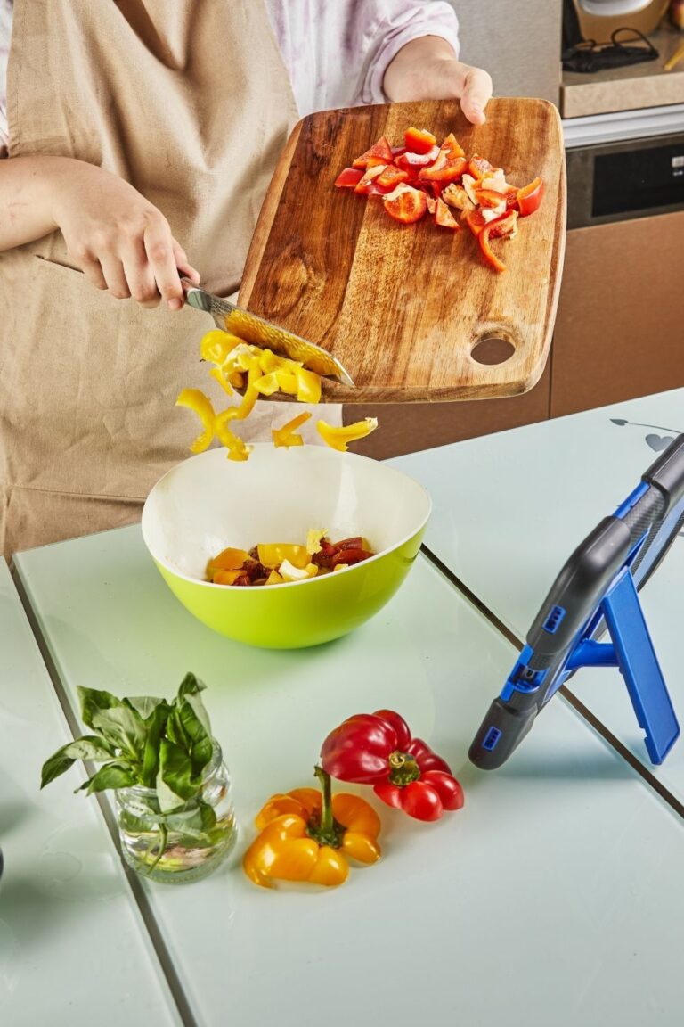Chopping veggies in front of an iPad.