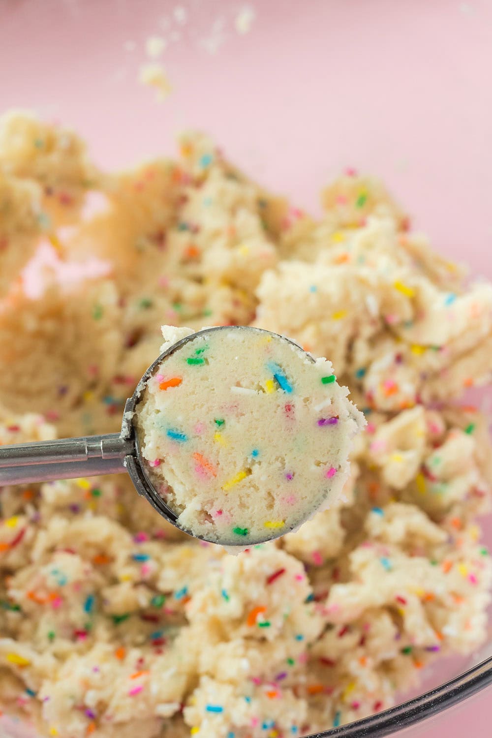 Scoop of cookie dough above the batter.