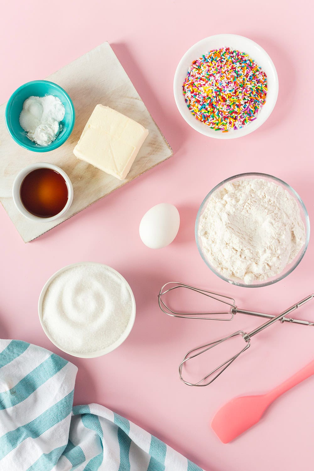 Butter, sugar, vanilla, and other cookie ingredients in bowls. 