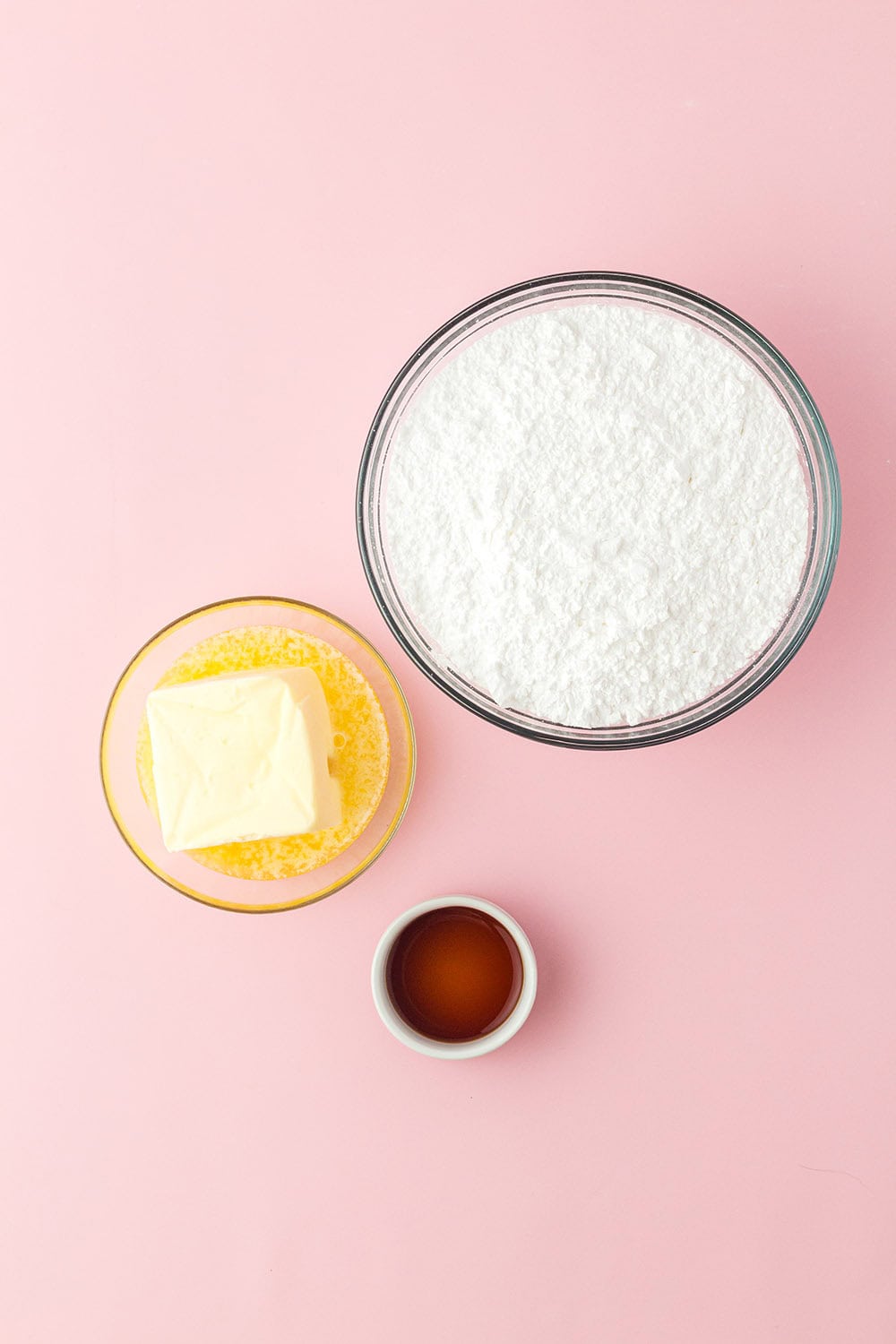 Powdered sugar, melted butter, and vanilla in small bowls. 