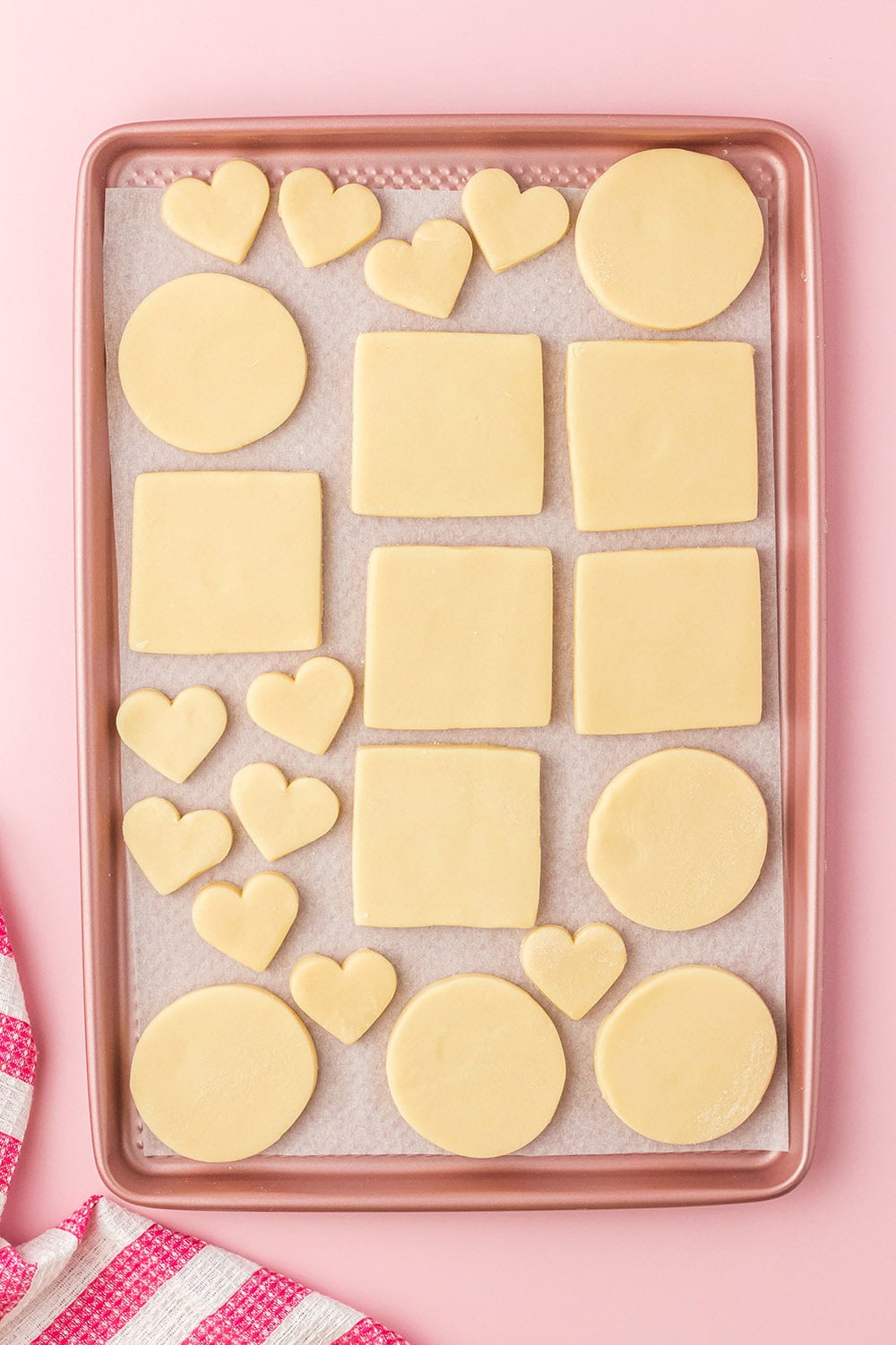 Dough cut into shapes and sitting on a cookie sheet. 