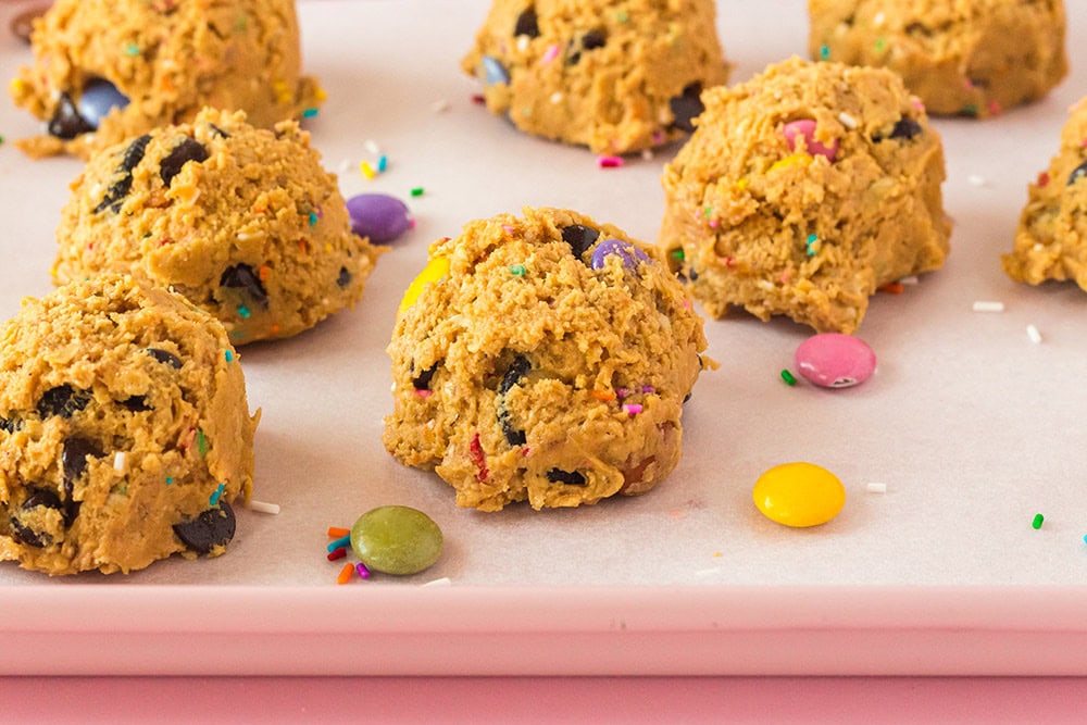Balls of cookie dough on a baking sheet. 