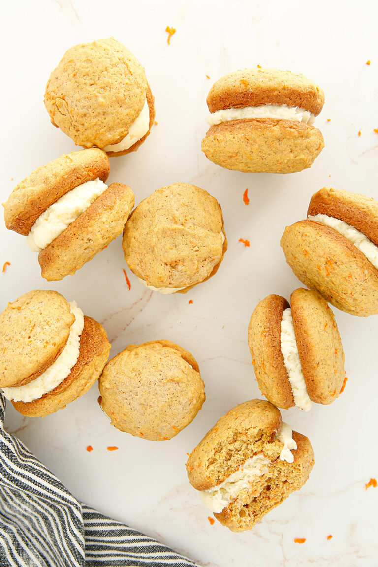 Carrot cake whoopie pies on a table.