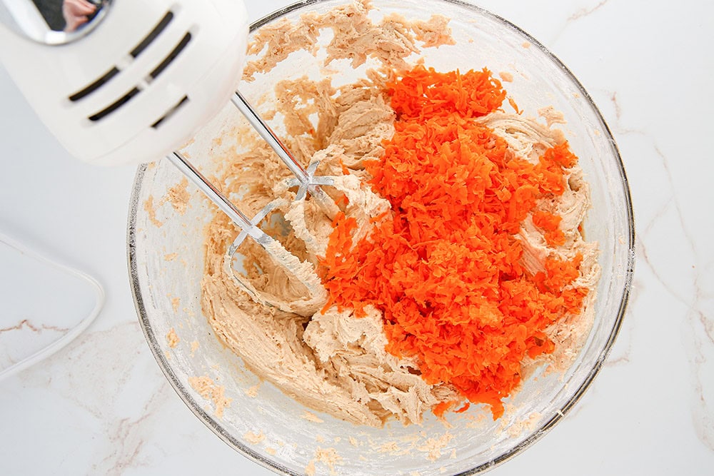 Batter with carrots added in with a mixer. 