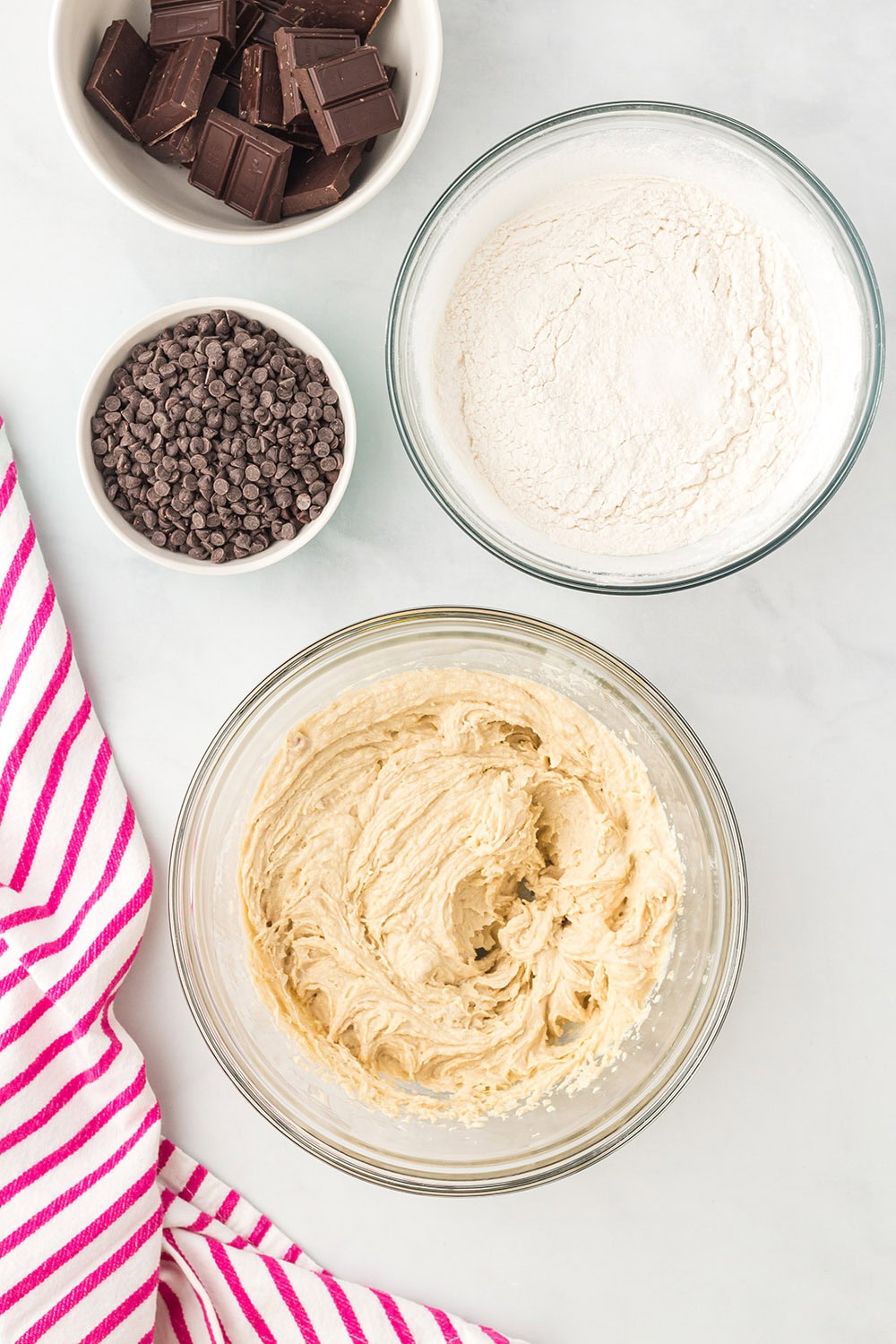 Dough, flour, and chips in bowls.
