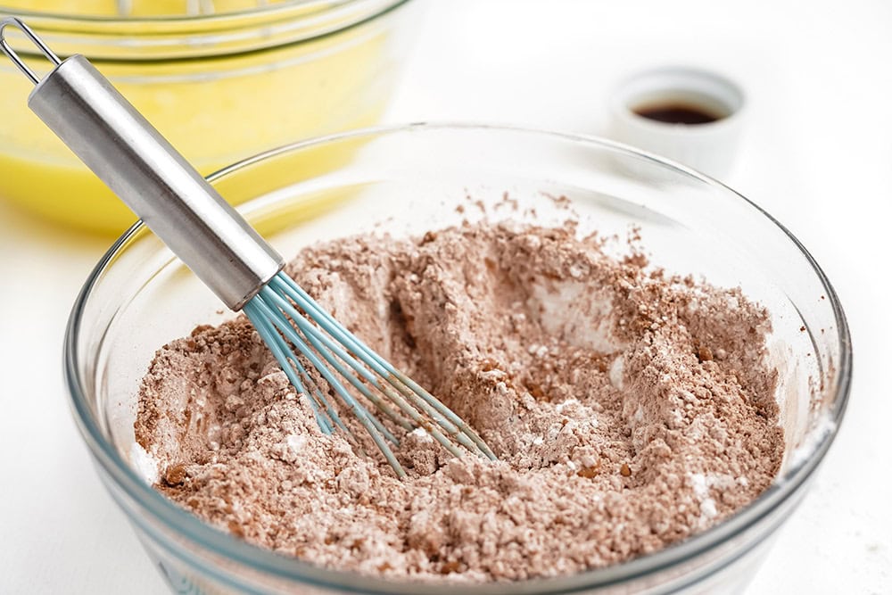 Ingredients in a mixing bowl with a whisk.