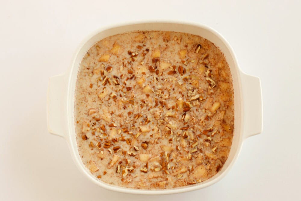 Apple baked oatmeal topped with pecans.