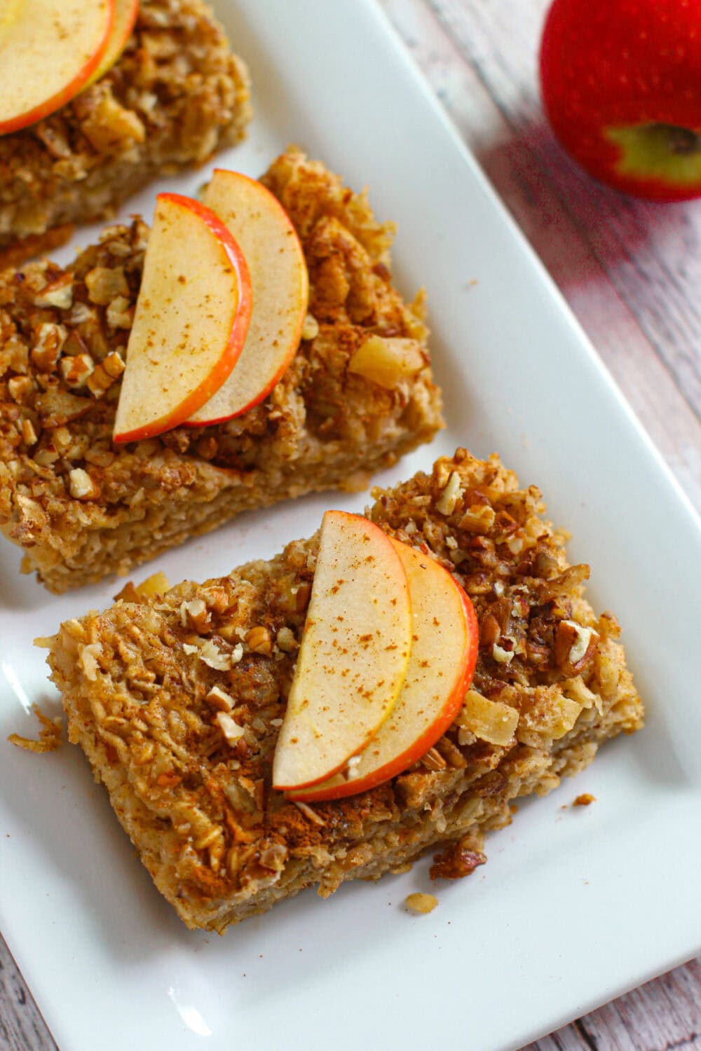 Baked oatmeal with apples on a tray.
