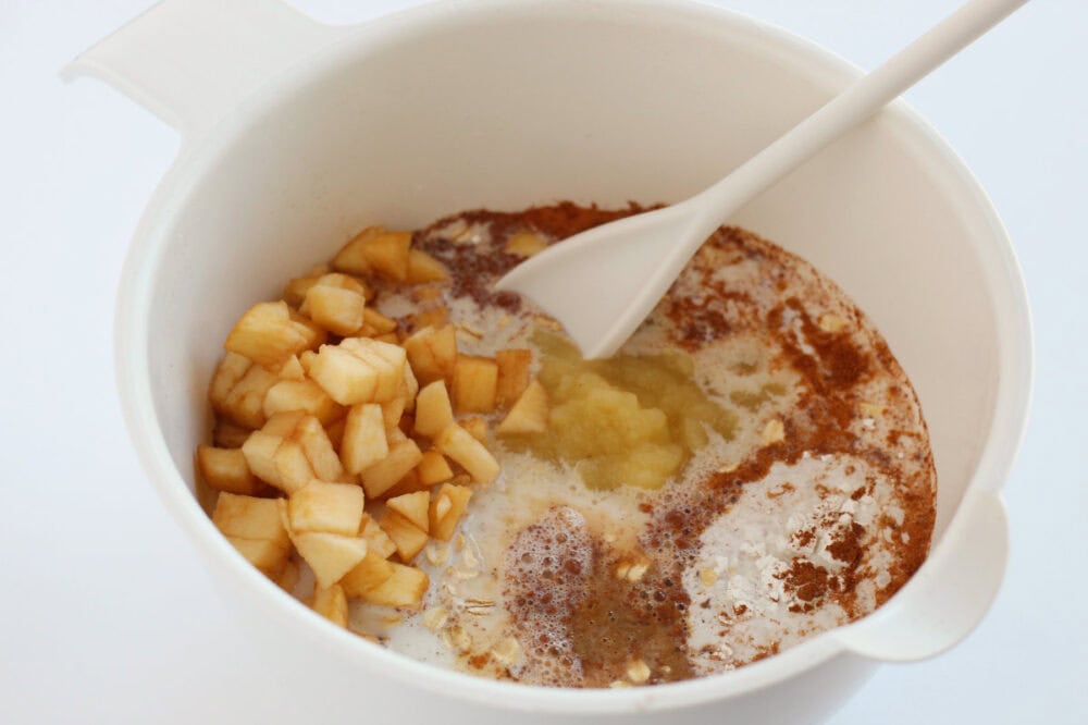 Mixing apples with oats and spices.