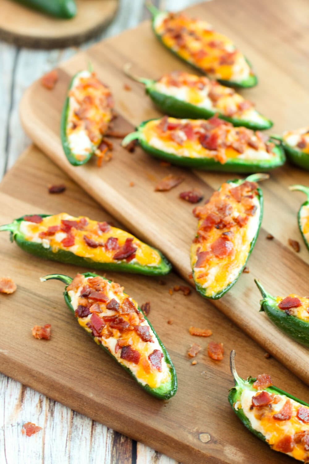 Several stuffed jalepeno poppers with bacon. 