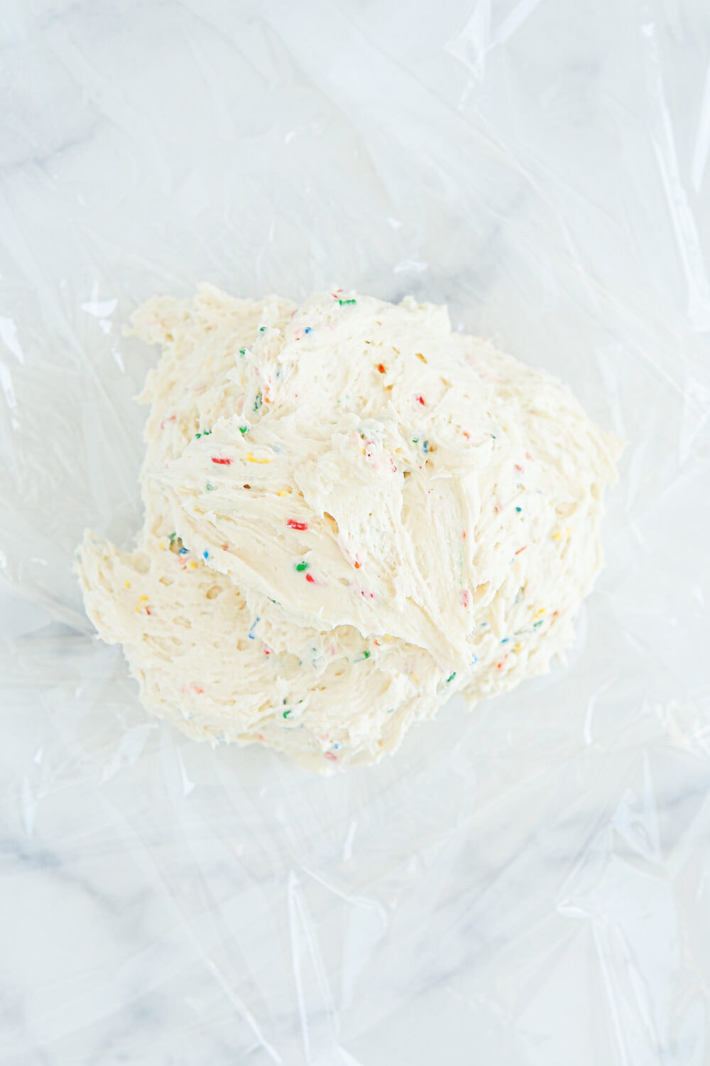 Cream cheese ball dip on plastic wrap. 