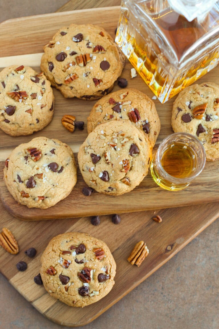 Chocolate chip pecan cookies next to bourbon.