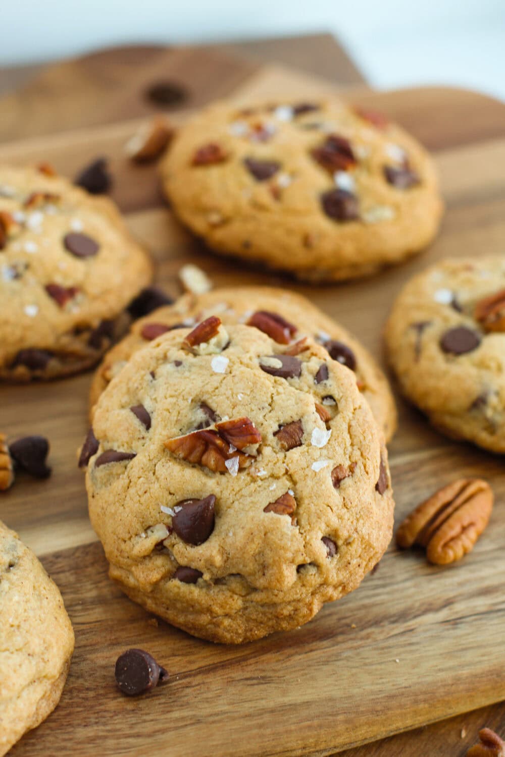 Bourbon chocolate chip cookies next to pecans and chocolate chips.