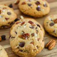 Bourbon chocolate chip cookies next to pecans and chocolate chips.