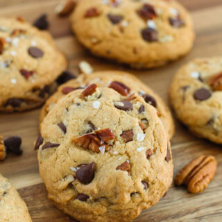 Bourbon chocolate chip cookies next to pecans and chocolate chips.