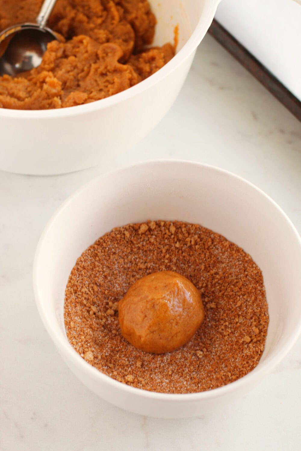 Rolling cookie dough into brown sugar coating. 