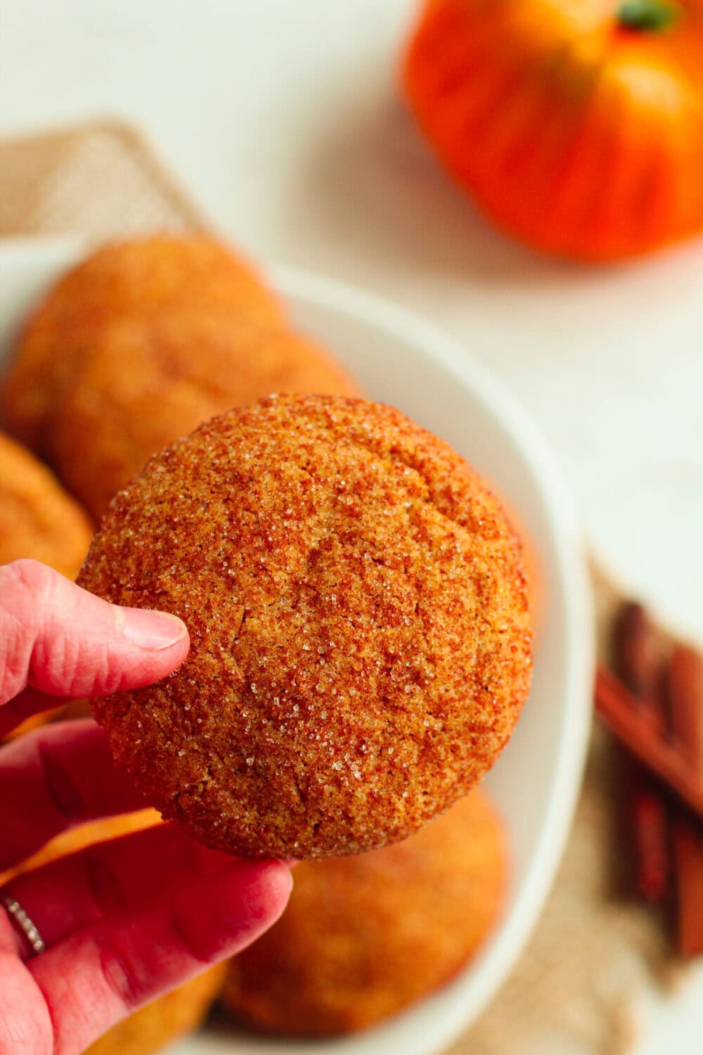 Holding a gluten-free pumpkin cookie. 