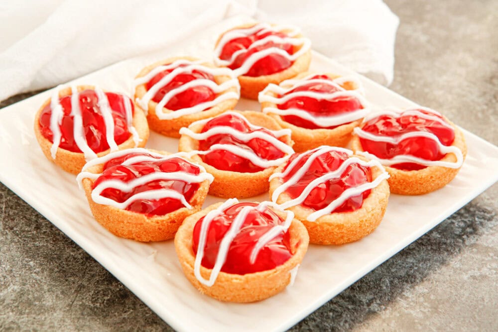 A plate full of cherry pie cookies. 